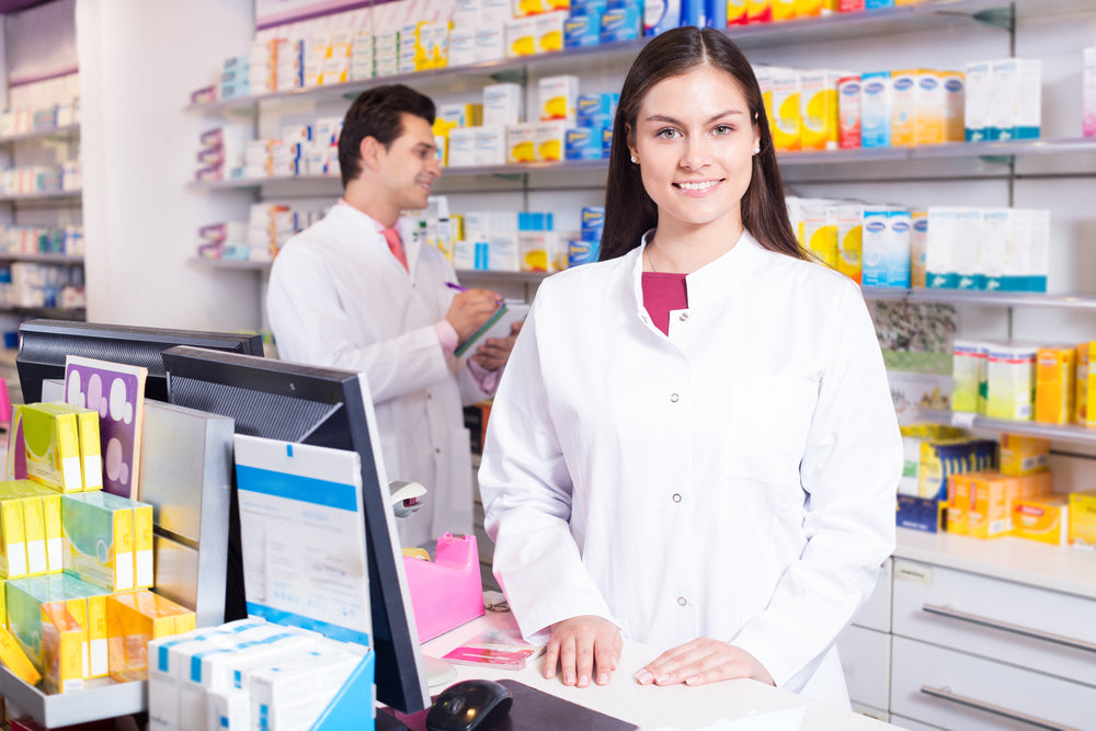 Two pharmacy technicians at a pharmacy counter